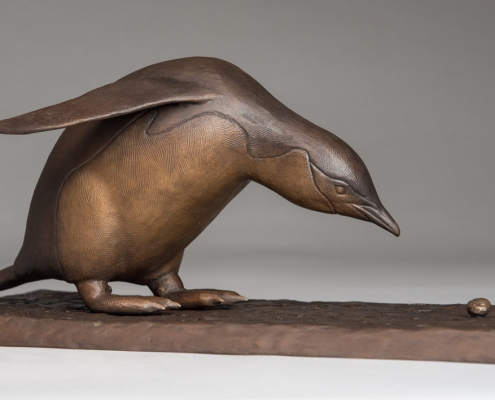 Bronze sculpture of a Chinstrap Penguin with a pebble by wildlife artist Anthony Smith
